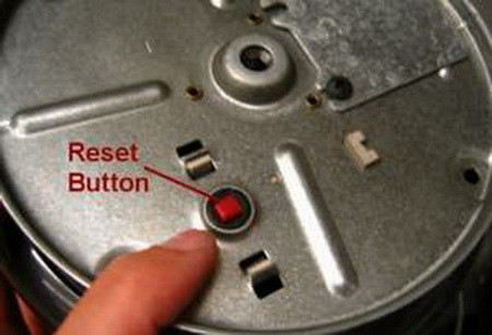 How to find the red button and reset the garbage disposal